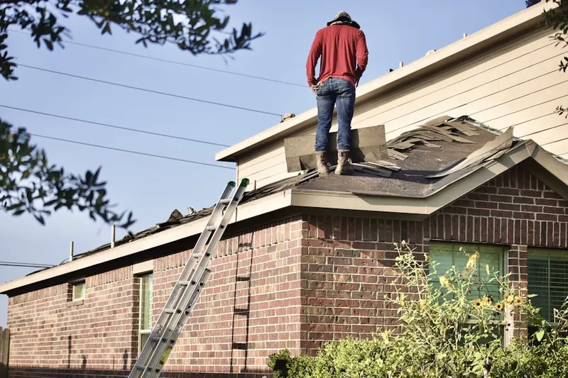 Professional roofer working on a residential roof in Highland Springs